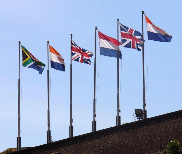 Six historical flags flying over the Castle of Good Hope